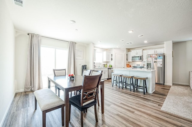 2012 Richard Ave, Sanger, CA 93657 - dining area with light wood finished floors, recessed lighting, and a textured ceiling