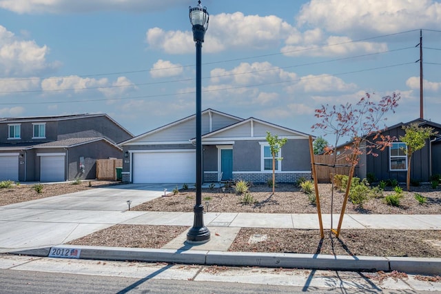 2012 Richard Ave, Sanger, CA 93657 - view of front of home with concrete driveway, an attached garage, and brick siding