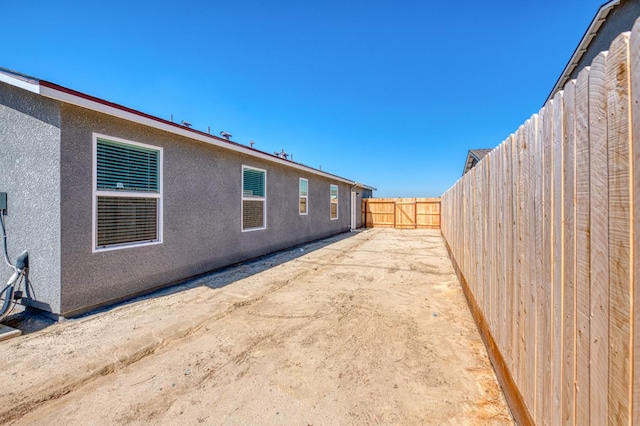 2012 Richard Ave, Sanger, CA 93657 - rear view of property with a fenced backyard and stucco siding