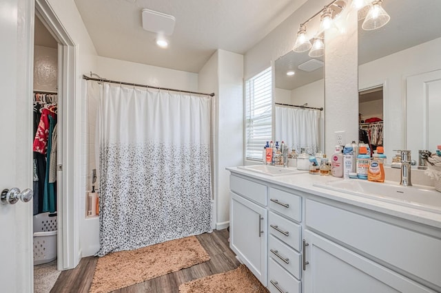 2012 Richard Ave, Sanger, CA 93657 - bathroom with double vanity, a spacious closet, wood finished floors, and a shower with curtain