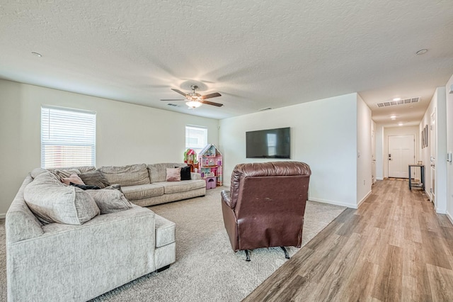 2012 Richard Ave, Sanger, CA 93657 - living area with light wood-style floors, a ceiling fan, and a textured ceiling