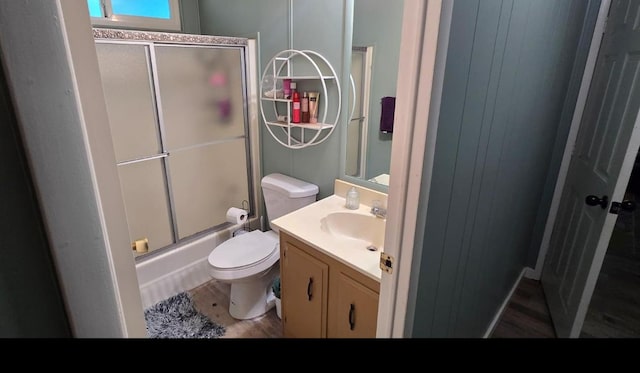 3415 E Lincoln Ave, Fresno, CA 93725 - bathroom with vanity, wood finished floors, and bath / shower combo with glass door