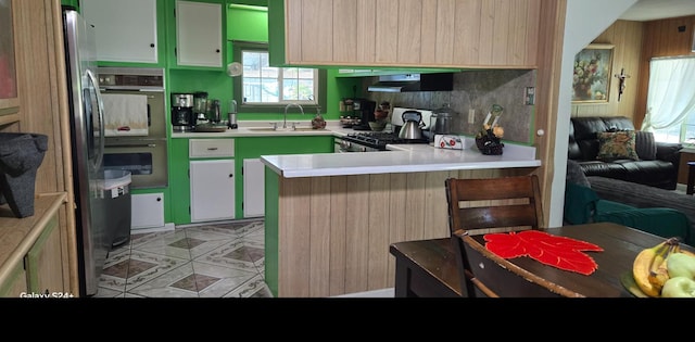 3415 E Lincoln Ave, Fresno, CA 93725 - kitchen featuring a peninsula, stainless steel appliances, healthy amount of natural light, and ventilation hood