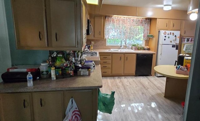 3415 E Lincoln Ave, Fresno, CA 93725 - kitchen featuring dishwasher, light wood-type flooring, light countertops, freestanding refrigerator, and stainless steel microwave