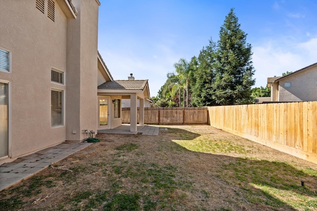 5647 N Tracy Ave, Fresno, CA 93722 - fenced backyard with a patio area