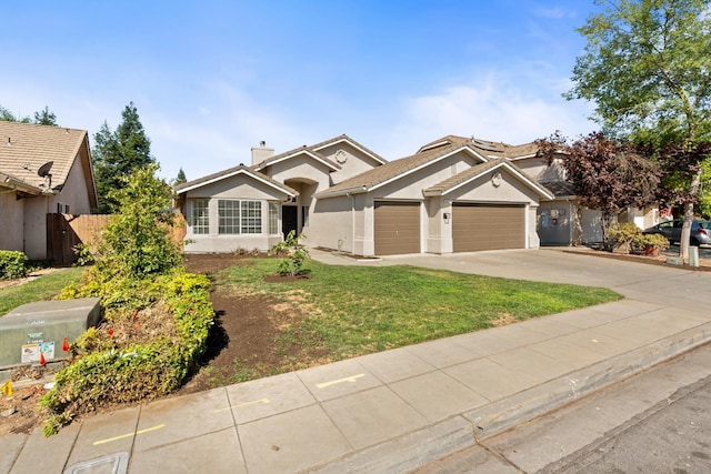 5647 N Tracy Ave, Fresno, CA 93722 - ranch-style house featuring an attached garage, concrete driveway, and stucco siding