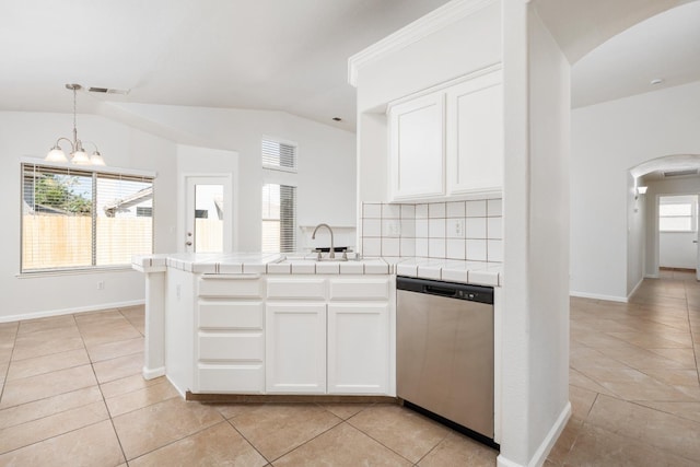 5647 N Tracy Ave, Fresno, CA 93722 - kitchen with dishwasher, arched walkways, tile counters, vaulted ceiling, and light tile patterned flooring