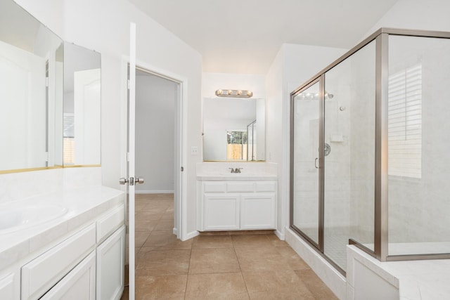 5647 N Tracy Ave, Fresno, CA 93722 - bathroom with a stall shower, two vanities, and tile patterned flooring