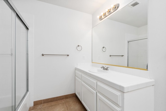 5647 N Tracy Ave, Fresno, CA 93722 - bathroom with vanity, tile patterned floors, and bath / shower combo with glass door