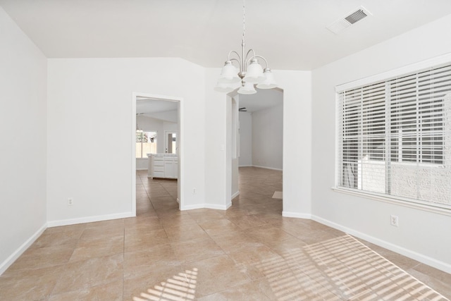 5647 N Tracy Ave, Fresno, CA 93722 - empty room featuring a chandelier, lofted ceiling, and light tile patterned floors