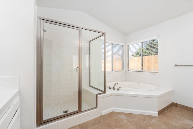 5647 N Tracy Ave, Fresno, CA 93722 - bathroom featuring vaulted ceiling, a garden tub, a shower stall, and vanity
