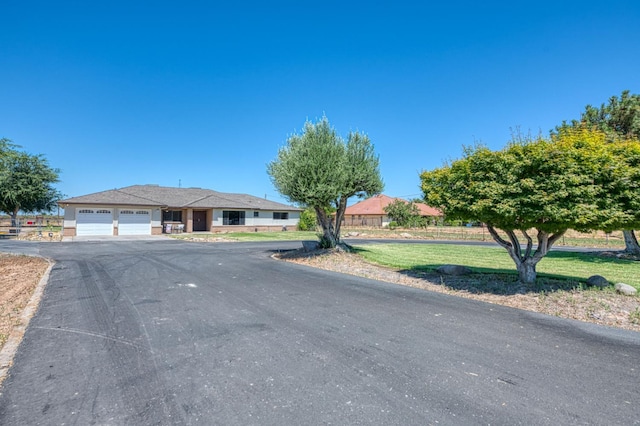 3377 N Bryan Ave, Fresno, CA 93723 - ranch-style home featuring an attached garage, driveway, and a front lawn