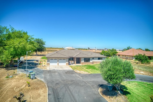 3377 N Bryan Ave, Fresno, CA 93723 - single story home with asphalt driveway, a garage, and a front yard