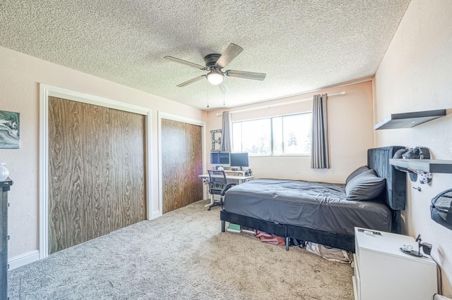 3377 N Bryan Ave, Fresno, CA 93723 - bedroom featuring multiple closets, carpet flooring, a desk, a textured ceiling, and a ceiling fan