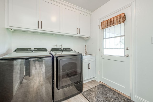 3377 N Bryan Ave, Fresno, CA 93723 - laundry area featuring independent washer and dryer, cabinet space, and light wood-type flooring