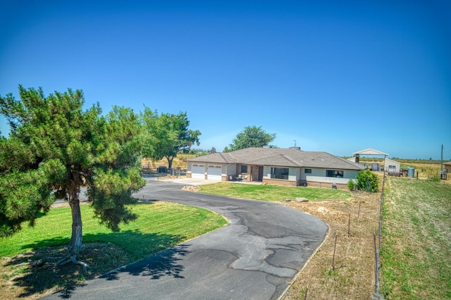 3377 N Bryan Ave, Fresno, CA 93723 - view of front of house with asphalt driveway, a garage, and a front yard