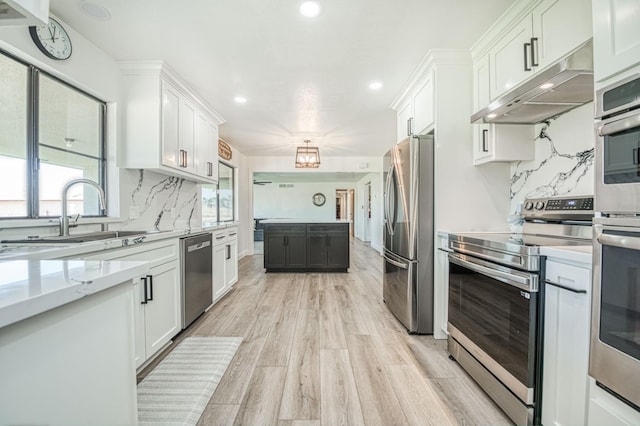3377 N Bryan Ave, Fresno, CA 93723 - kitchen featuring appliances with stainless steel finishes, under cabinet range hood, recessed lighting, white cabinets, and light wood-style flooring