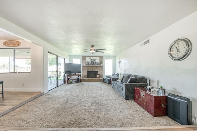 3377 N Bryan Ave, Fresno, CA 93723 - living area with ceiling fan, a fireplace, and a textured ceiling