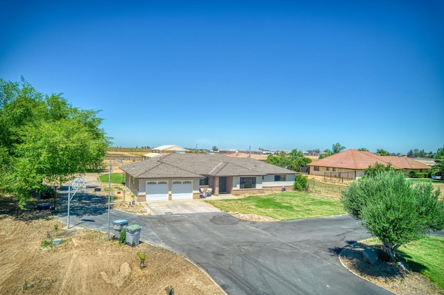 3377 N Bryan Ave, Fresno, CA 93723 - ranch-style house with asphalt driveway, an attached garage, and a front yard
