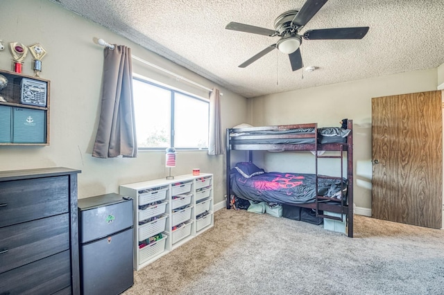 3377 N Bryan Ave, Fresno, CA 93723 - carpeted bedroom with a textured ceiling, ceiling fan, and freestanding refrigerator