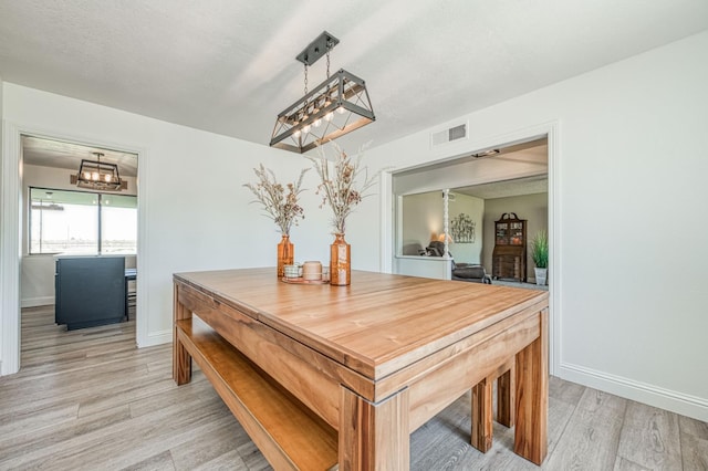 3377 N Bryan Ave, Fresno, CA 93723 - dining area featuring a chandelier and light wood finished floors