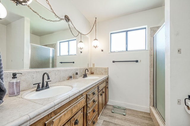 3377 N Bryan Ave, Fresno, CA 93723 - full bath featuring double vanity, an enclosed shower, wood finished floors, and backsplash