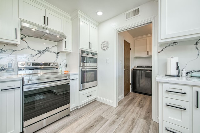 3377 N Bryan Ave, Fresno, CA 93723 - kitchen featuring stainless steel appliances, under cabinet range hood, washer / dryer, light wood-style floors, and white cabinets
