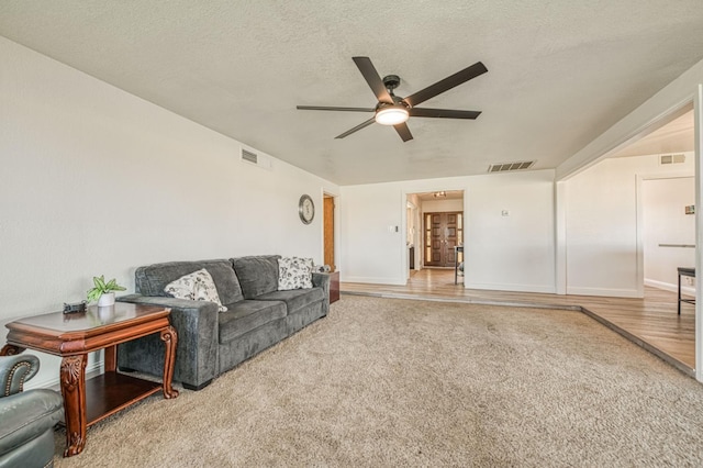 3377 N Bryan Ave, Fresno, CA 93723 - carpeted living room with a ceiling fan and a textured ceiling