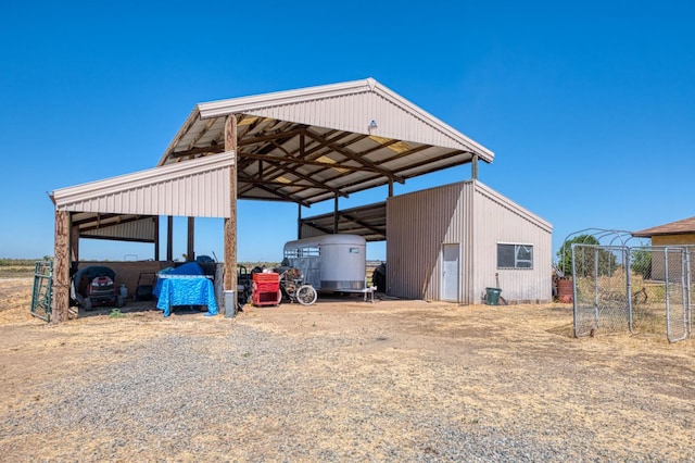 3377 N Bryan Ave, Fresno, CA 93723 - view of outdoor structure featuring dirt driveway and a carport