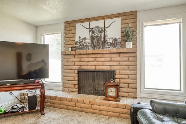 3377 N Bryan Ave, Fresno, CA 93723 - carpeted living room with a textured ceiling and a fireplace