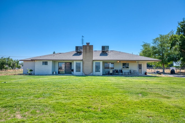 3377 N Bryan Ave, Fresno, CA 93723 - back of property featuring a chimney, a patio area, and stucco siding