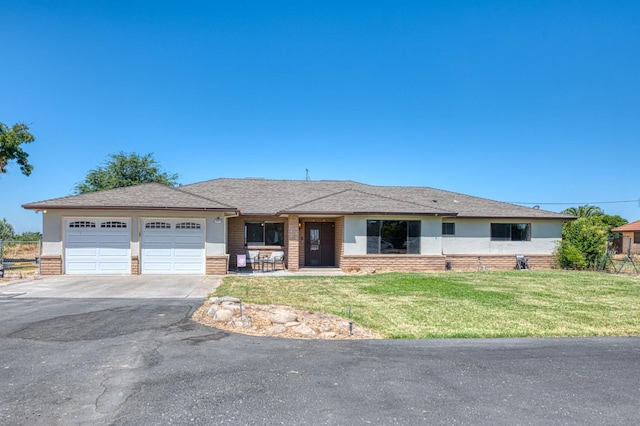 3377 N Bryan Ave, Fresno, CA 93723 - view of front of property featuring asphalt driveway, a garage, a front yard, and brick siding
