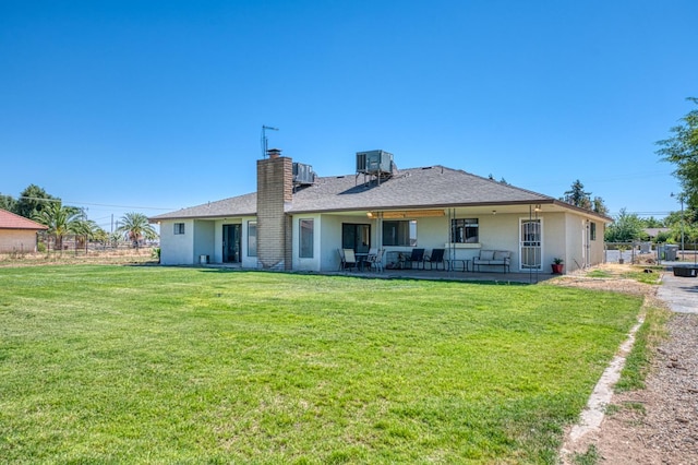 3377 N Bryan Ave, Fresno, CA 93723 - rear view of property with stucco siding, a chimney, a patio, and a yard