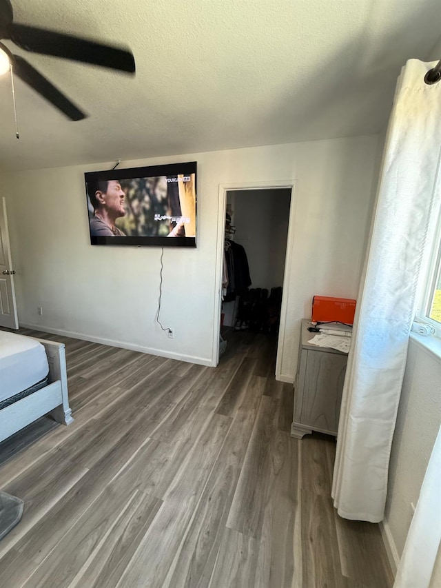 2662 Yerba St, Selma, CA 93662 - bedroom with wood finished floors, a walk in closet, ceiling fan, and a textured ceiling