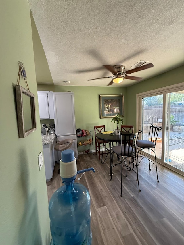 2662 Yerba St, Selma, CA 93662 - dining space featuring a textured ceiling, dark wood-style flooring, and a ceiling fan