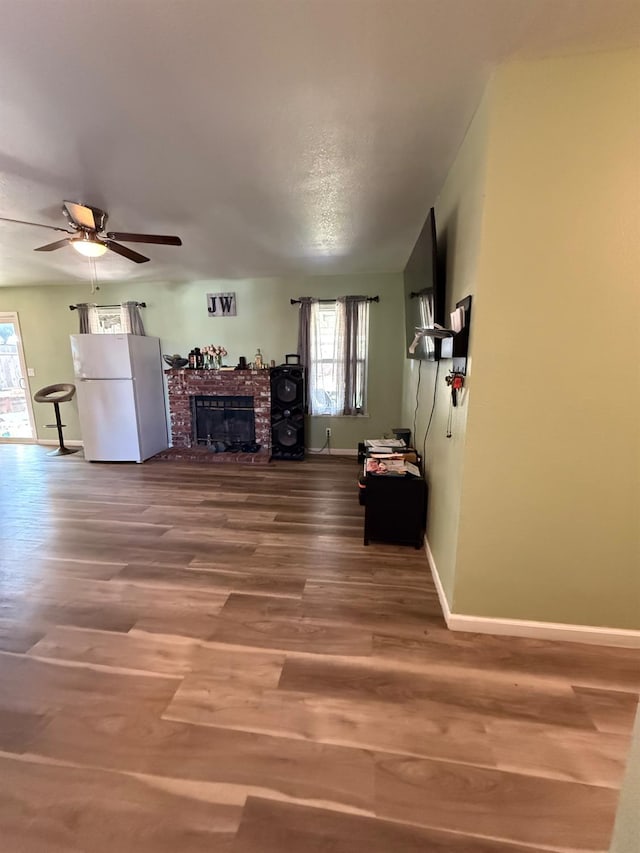 2662 Yerba St, Selma, CA 93662 - living area with a brick fireplace, wood finished floors, and a ceiling fan