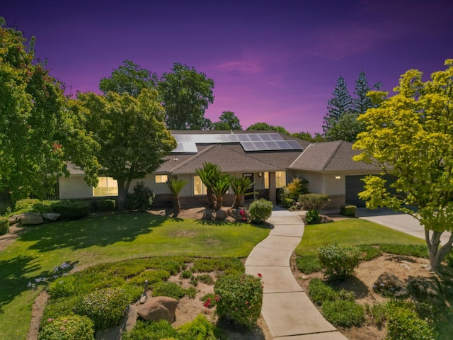 6372 N Benedict Ave, Fresno, CA 93711 - view of front of property with a lawn, solar panels, driveway, and an attached garage