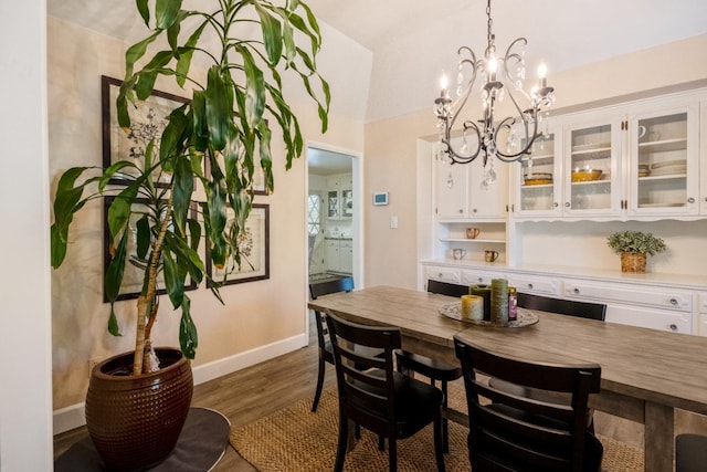 6372 N Benedict Ave, Fresno, CA 93711 - dining area featuring a chandelier, dark wood-style flooring, and vaulted ceiling
