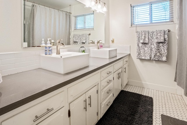 6372 N Benedict Ave, Fresno, CA 93711 - full bath with double vanity, tile patterned floors, tasteful backsplash, and a shower with curtain