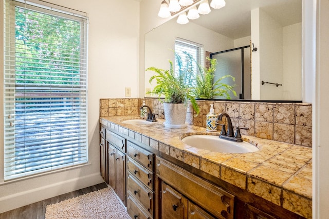 6372 N Benedict Ave, Fresno, CA 93711 - full bath with tasteful backsplash, double vanity, a shower stall, and wood finished floors