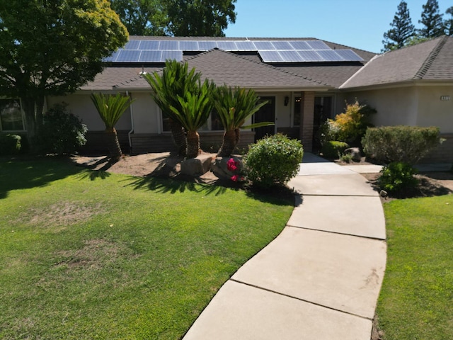 6372 N Benedict Ave, Fresno, CA 93711 - view of front of home with a front lawn and solar panels
