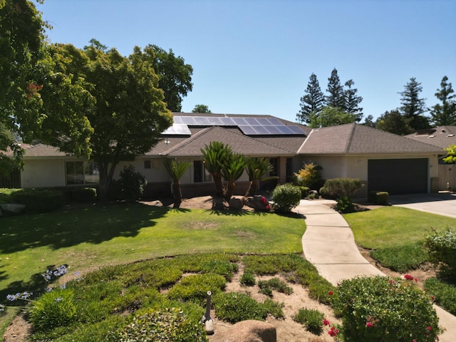 6372 N Benedict Ave, Fresno, CA 93711 - view of front facade featuring solar panels, concrete driveway, a front lawn, and an attached garage