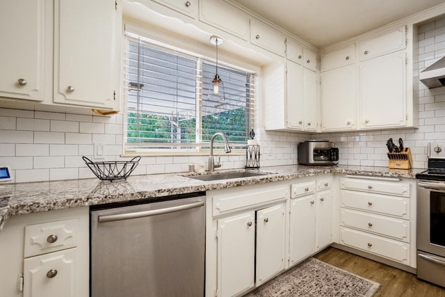 6372 N Benedict Ave, Fresno, CA 93711 - kitchen featuring stainless steel appliances, light wood-style flooring, decorative backsplash, white cabinetry, and light stone counters