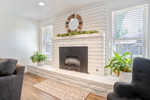 6372 N Benedict Ave, Fresno, CA 93711 - living area with wood finished floors and a brick fireplace