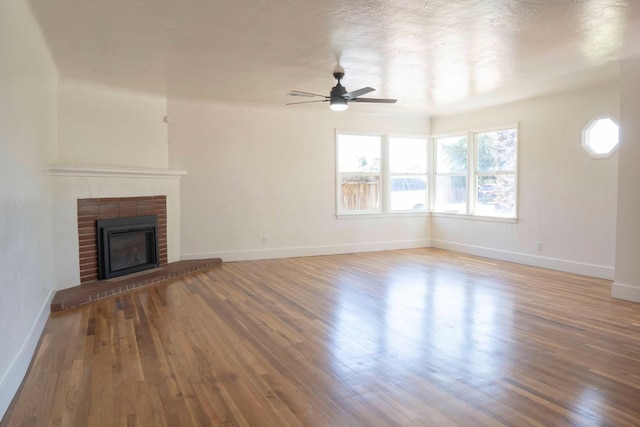 4119 Arden Dr S, Fresno, CA 93703 - unfurnished living room featuring ceiling fan, wood finished floors, and a brick fireplace