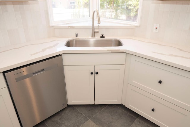 4119 Arden Dr S, Fresno, CA 93703 - kitchen featuring stainless steel dishwasher, dark tile patterned floors, white cabinetry, and light stone counters