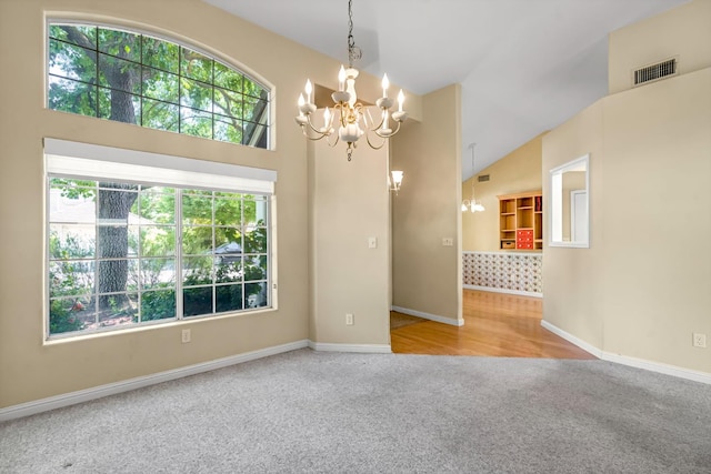 1210 E Province Dr, Fresno, CA 93720 - carpeted empty room with a chandelier and high vaulted ceiling