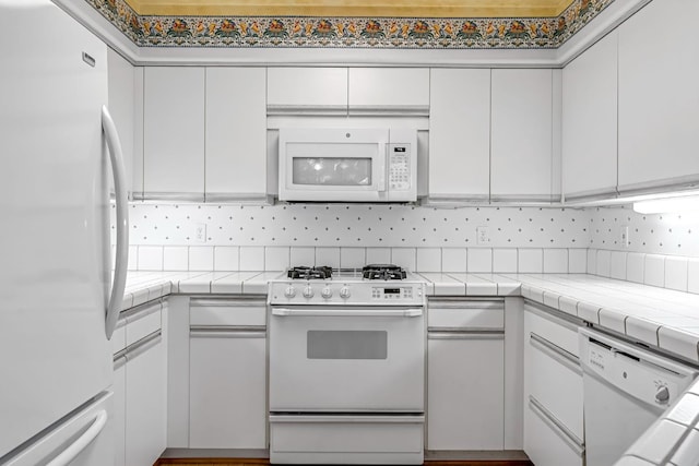 1210 E Province Dr, Fresno, CA 93720 - kitchen with white appliances, white cabinetry, tile countertops, and backsplash