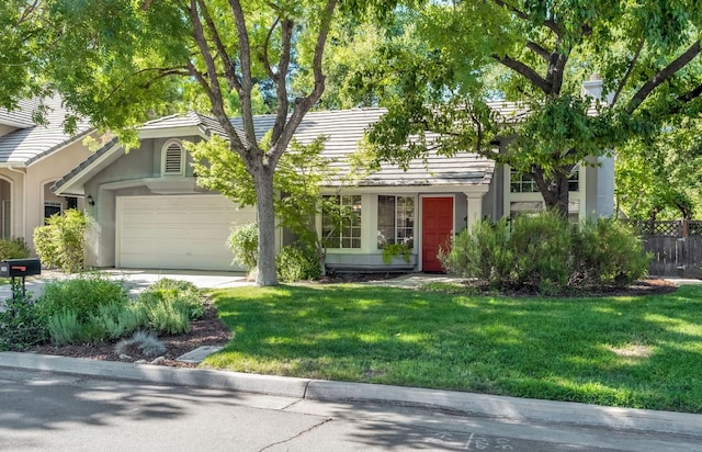 1210 E Province Dr, Fresno, CA 93720 - view of front of home with a garage, stucco siding, a tiled roof, and driveway