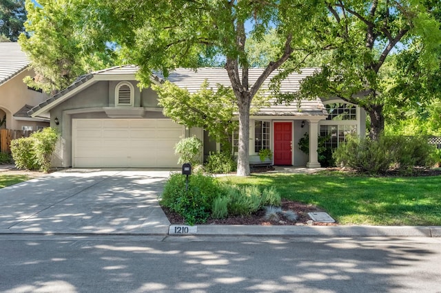 1210 E Province Dr, Fresno, CA 93720 - view of front facade with driveway, a garage, a tiled roof, and stucco siding